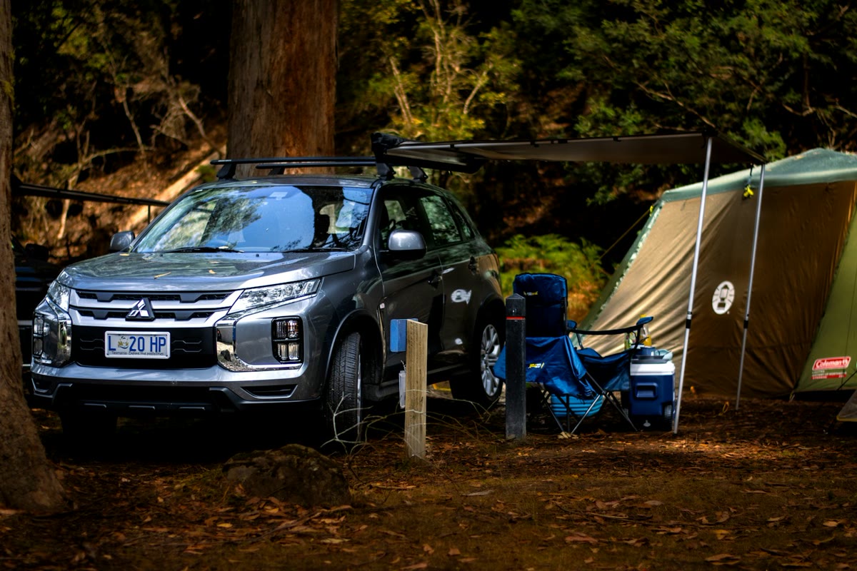 SUV and tent at a campsite